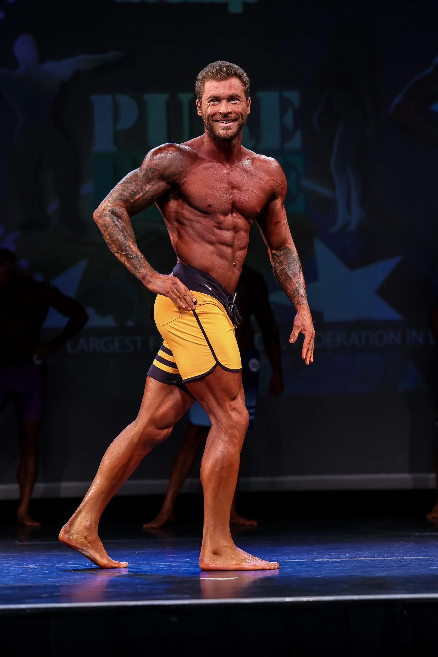 Luke on stage at a bodybuilding show